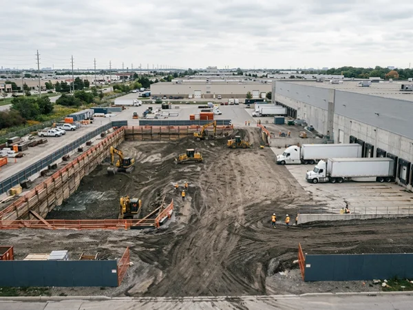 Loading dock pit excavation beside an operating warehouse